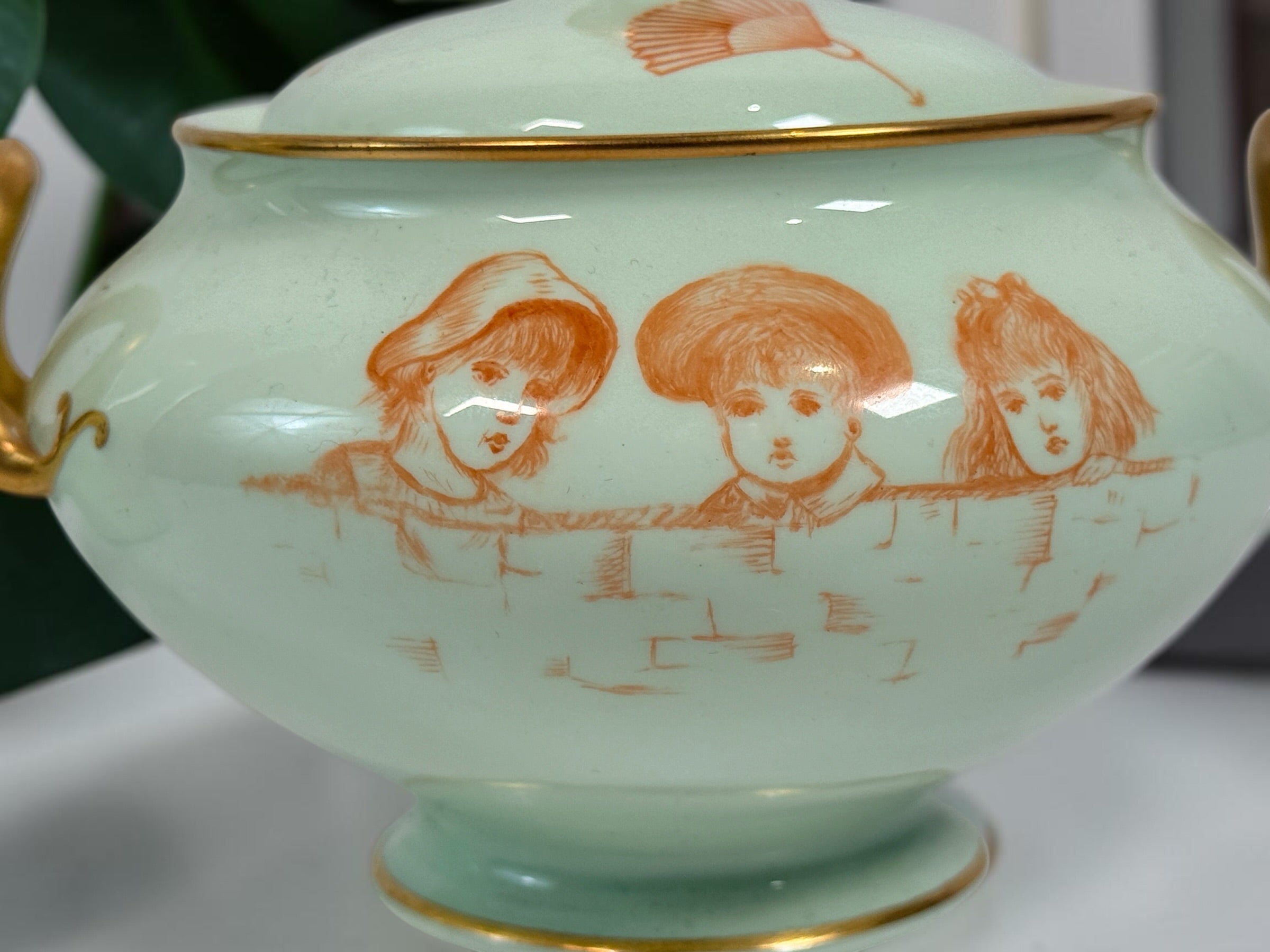 Celadon porcelain wash set with pitcher and covered chamber pot, hand-painted children, gold trim and M.A.P. signature; antique or vintage replica status unconfirmed.