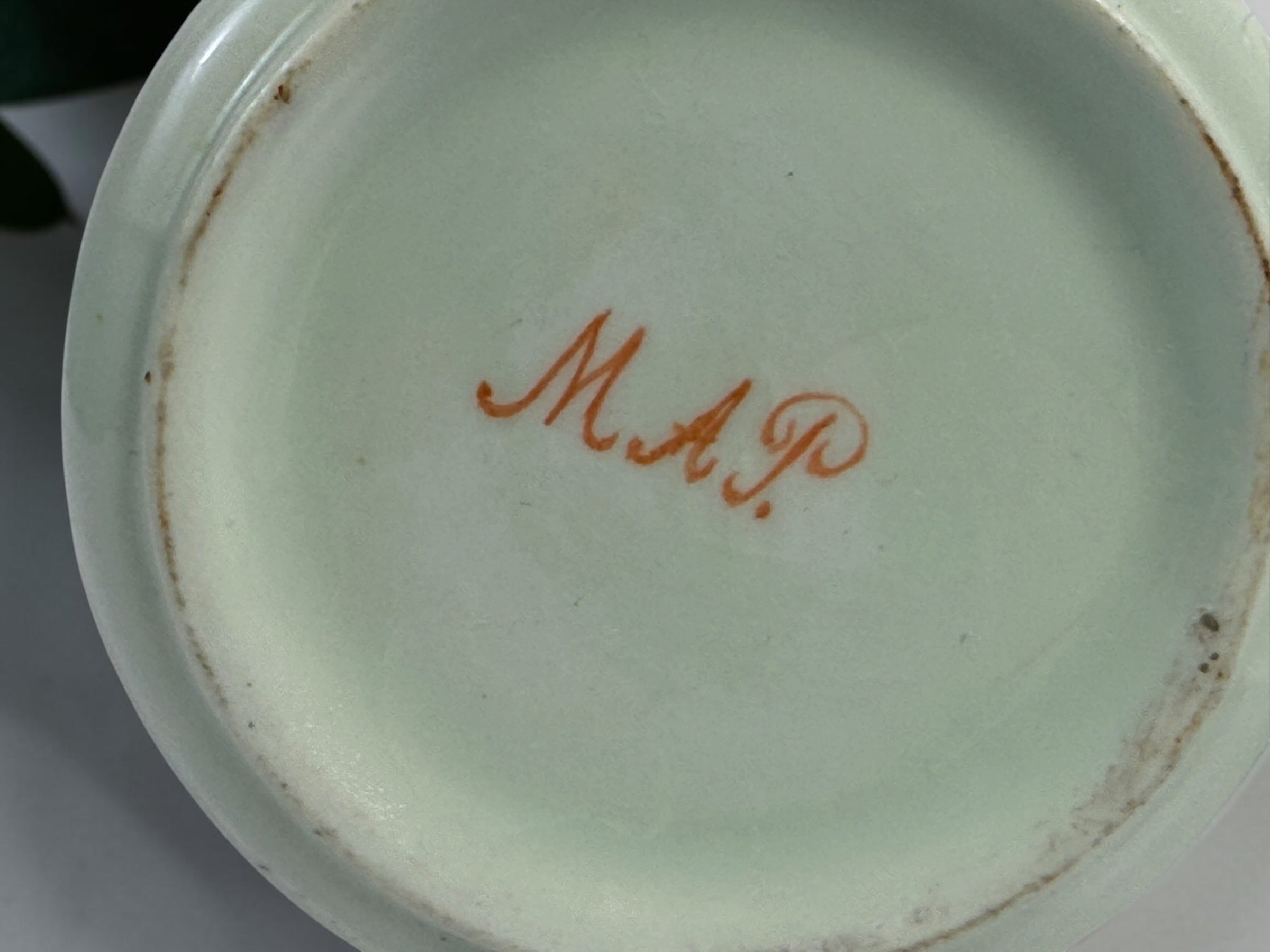 Celadon porcelain wash set with pitcher and covered chamber pot, hand-painted children, gold trim and M.A.P. signature; antique or vintage replica status unconfirmed.