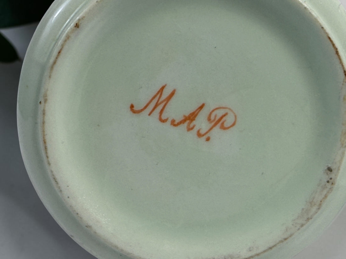 Celadon porcelain wash set with pitcher and covered chamber pot, hand-painted children, gold trim and M.A.P. signature; antique or vintage replica status unconfirmed.