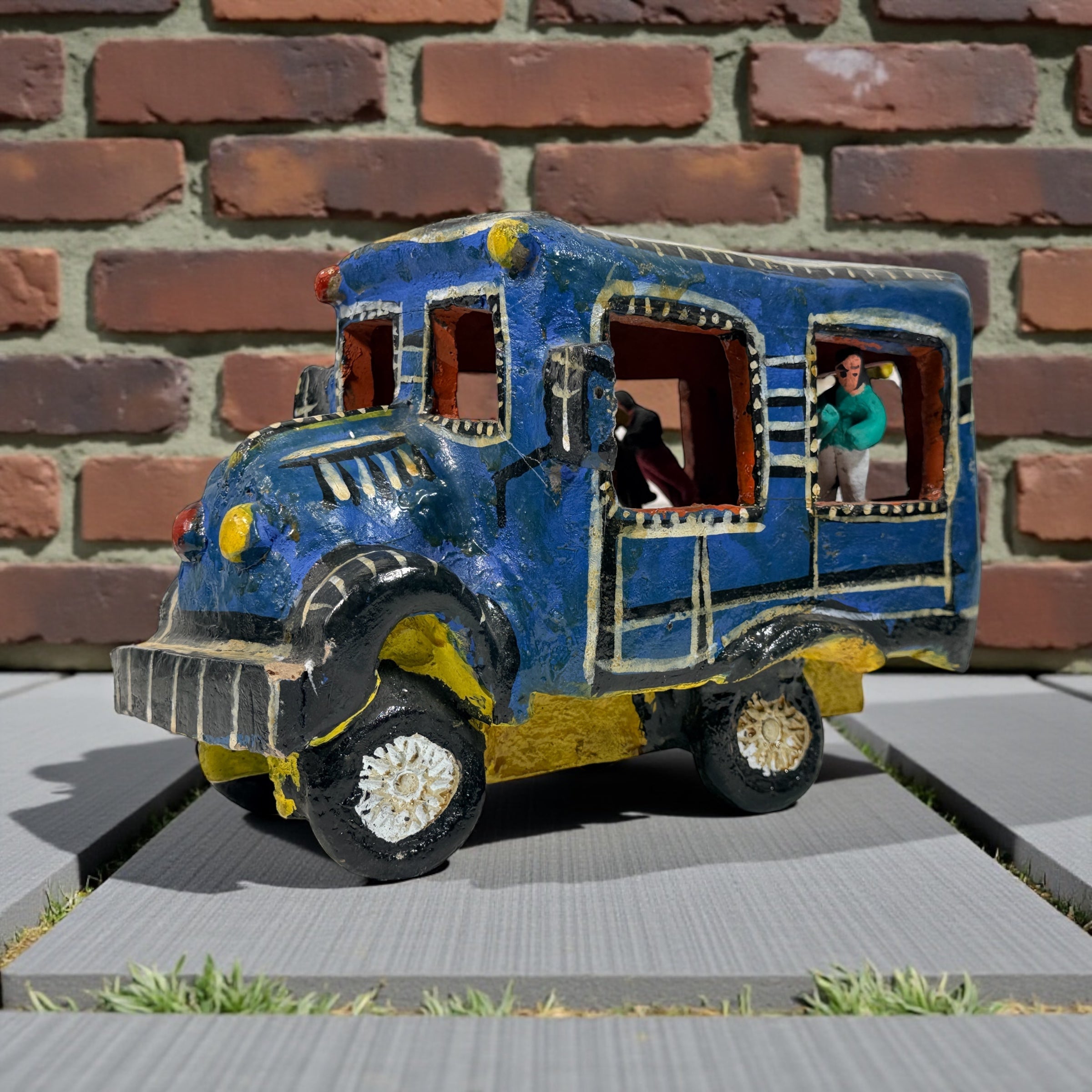 Vintage Mexican papier-mâché colectivo bus sculpture with hand-modeled interior figures. Folk art narrative piece with bold color and strong display presence.