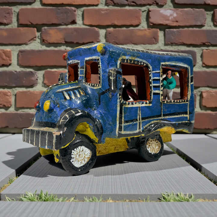 Vintage Mexican papier-mâché colectivo bus sculpture with hand-modeled interior figures. Folk art narrative piece with bold color and strong display presence.