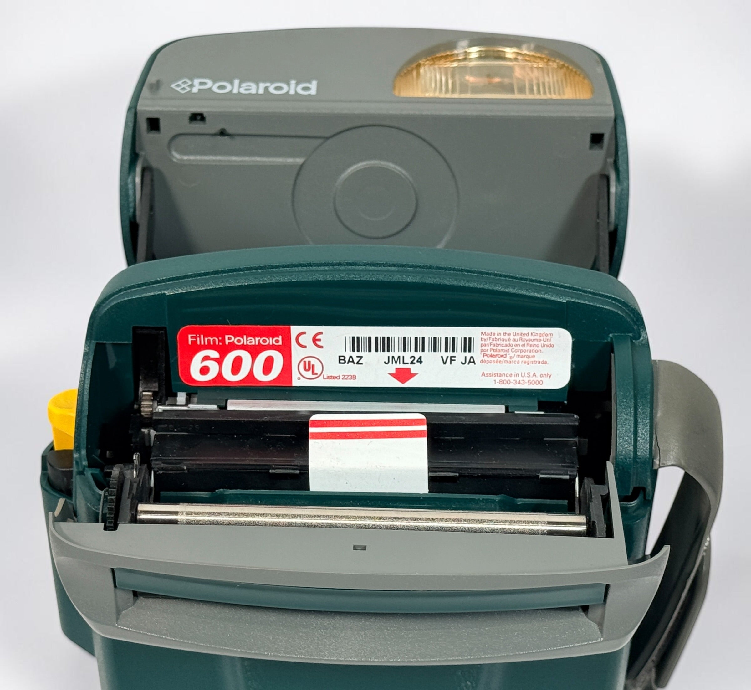 Vintage green Polaroid OneStep Express instant camera for 600 film with built-in flash and close-up mode. Untested and sold as-is.