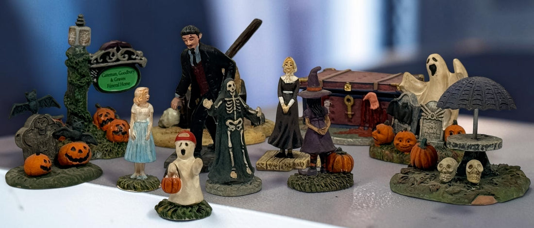 Hawthorne Village The Munsters Halloween Village 12-piece resin accessory lot with figures, pumpkins, ghosts, witch, cauldron and graveyard scenes.