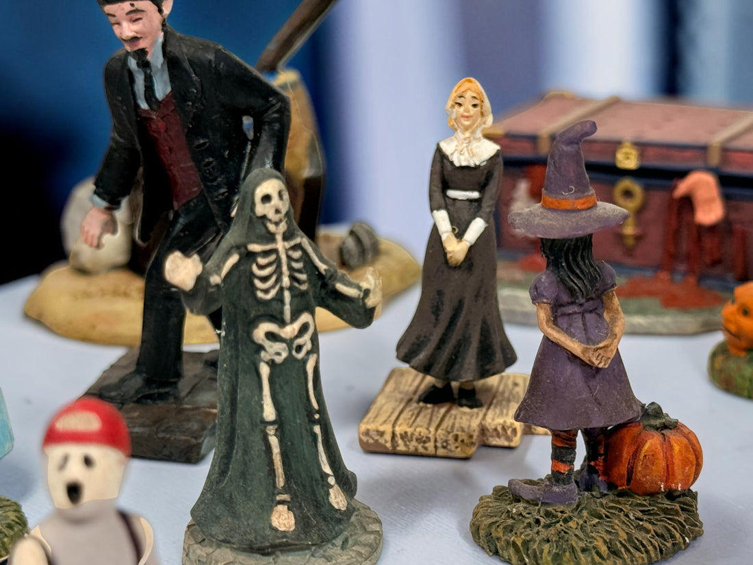 Hawthorne Village The Munsters Halloween Village 12-piece resin accessory lot with figures, pumpkins, ghosts, witch, cauldron and graveyard scenes.