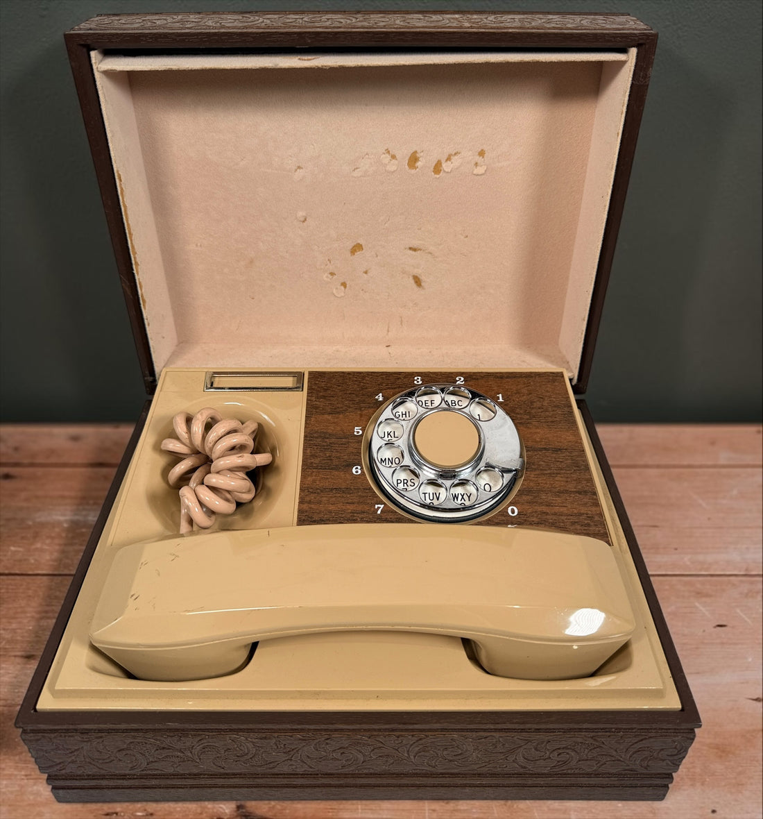 Vintage 1970s Deco-Tel rotary telephone hidden inside a decorative carved-look wood chest. Untested with cut line cord; sold as-is.