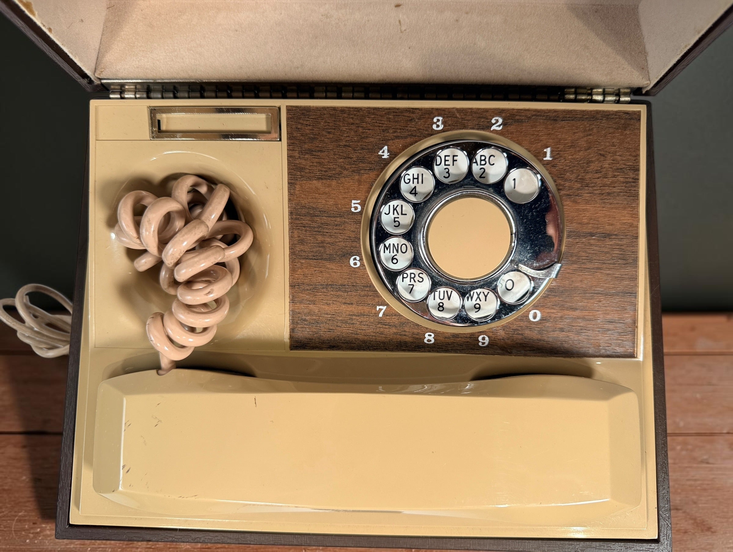 Vintage 1970s Deco-Tel rotary telephone hidden inside a decorative carved-look wood chest. Untested with cut line cord; sold as-is.