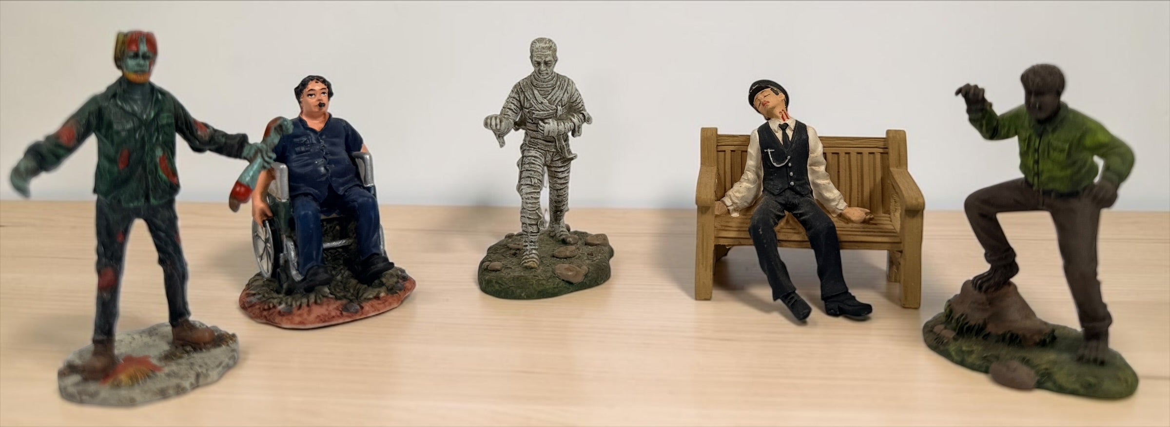 Retired Hawthorne Village horror figurine lot with Wolf Man, Mummy, Conductor, Franklin and Dawn of the Dead Helicopter Zombie.