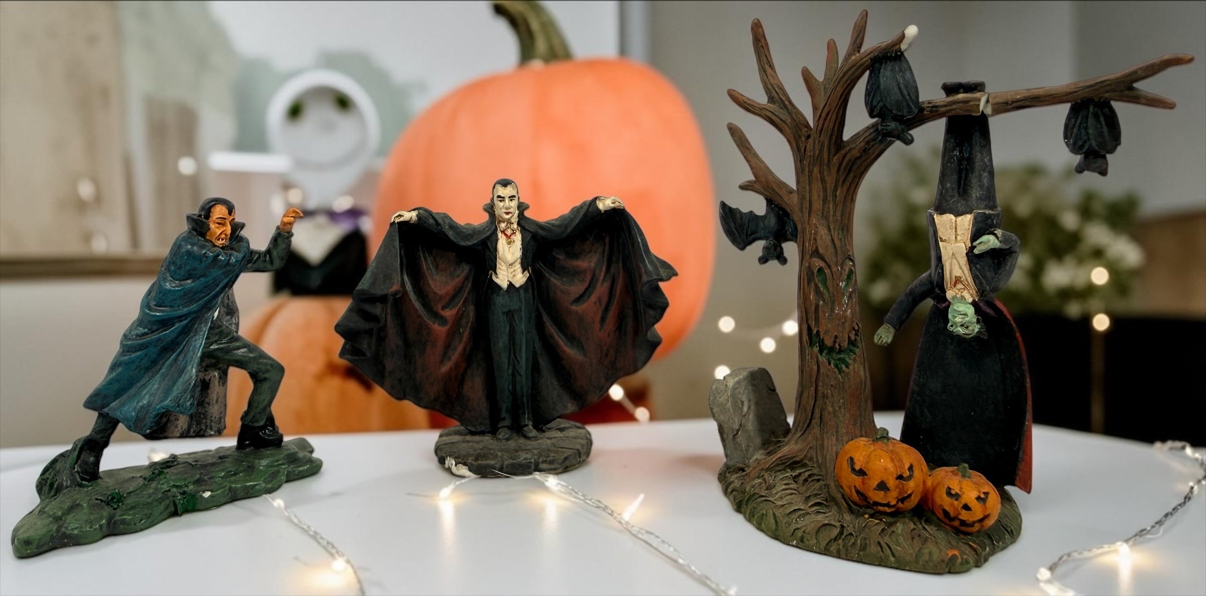 Lot of three retired Hawthorne Village Dracula and Munsters resin figurines, including Grandpa Getting Comfy. Vintage Universal Monsters decor
