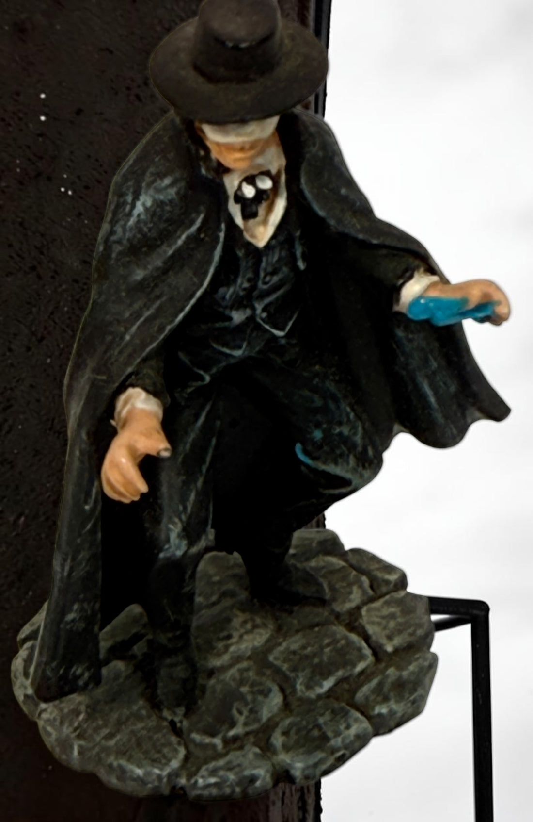 Vintage Phantom of the Opera–style resin figurine with black cape and cobblestone base. Damaged with missing accessories; sold as-is.