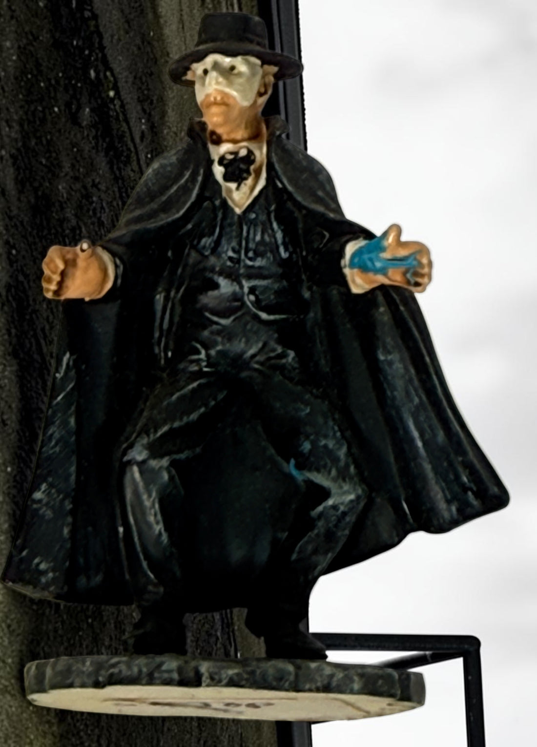 Vintage Phantom of the Opera–style resin figurine with black cape and cobblestone base. Damaged with missing accessories; sold as-is.