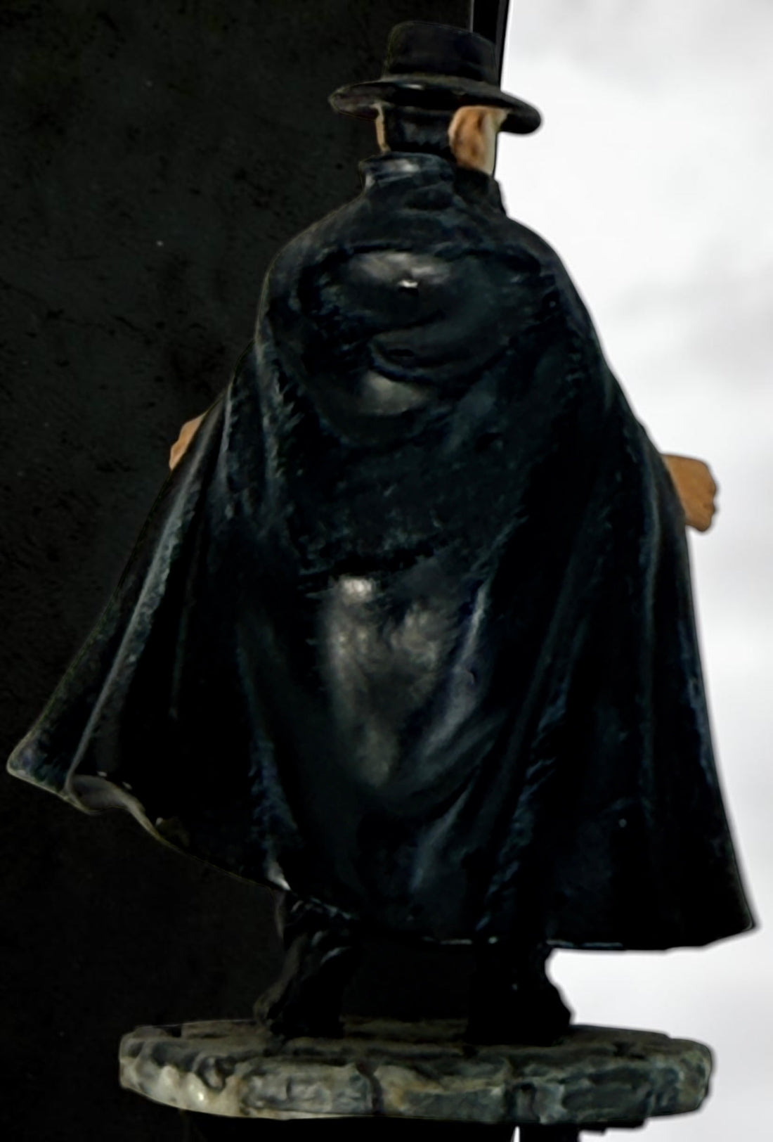 Vintage Phantom of the Opera–style resin figurine with black cape and cobblestone base. Damaged with missing accessories; sold as-is.
