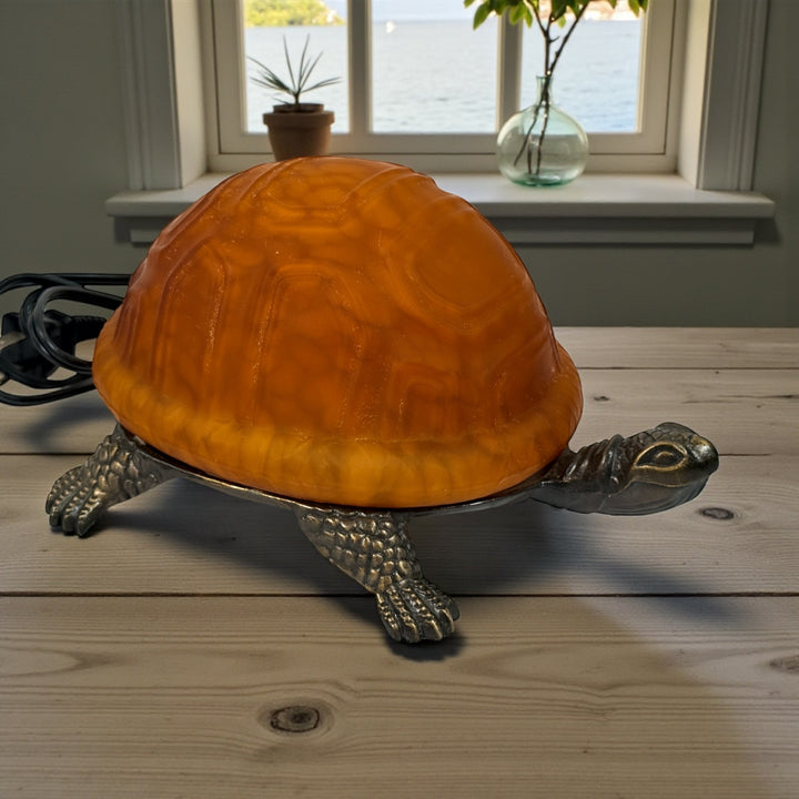 Mid-century turtle lamp with amber glass shell and bronze base. Warm ambient lighting for den, nursery, or cabin decor. Tested and in clean working condition.