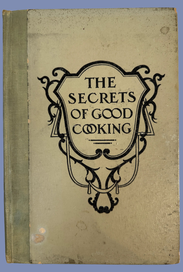 Book titled 'The Secrets of Good Cooking' with decorative cover on a white background