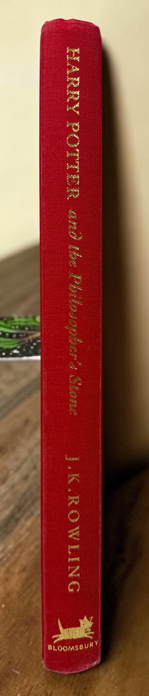 Collectible 1999 Harry Potter Philosopher’s Stone UK deluxe third printing with red cloth binding, gilt page edges and ribbon marker.