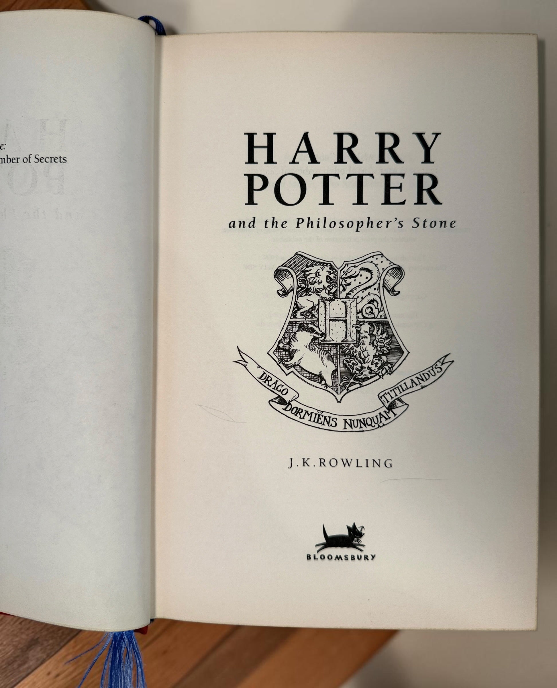 Collectible 1999 Harry Potter Philosopher’s Stone UK deluxe third printing with red cloth binding, gilt page edges and ribbon marker.