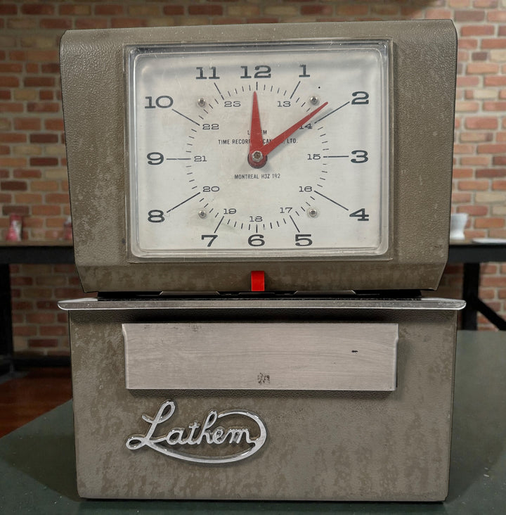 Vintage Lathem mechanical punch time clock. Works but needs new ribbon and key. Ideal for restoration, parts, or industrial office decor. Sold as-is.
