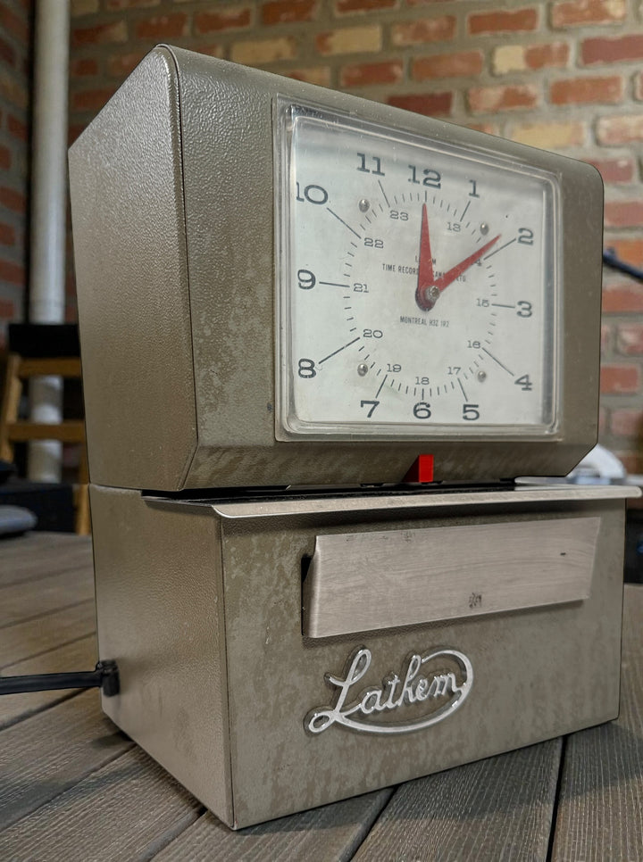 Vintage Lathem mechanical punch time clock. Works but needs new ribbon and key. Ideal for restoration, parts, or industrial office decor. Sold as-is.