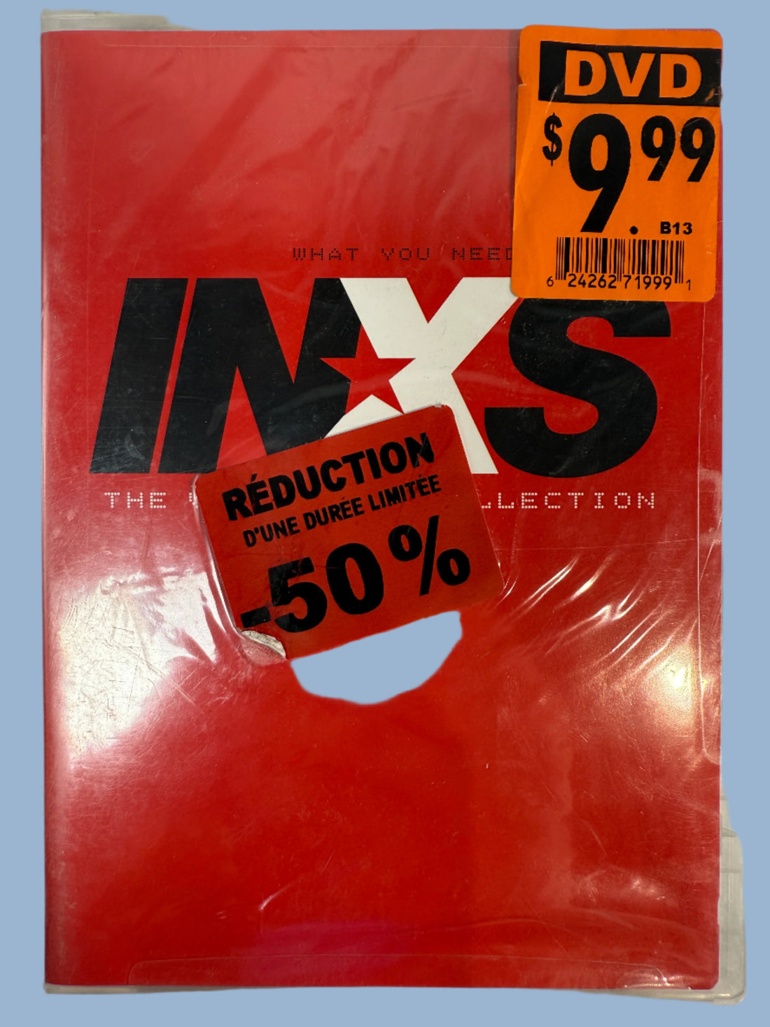 Red DVD case with 'INXS' branding and a discount label on a white background