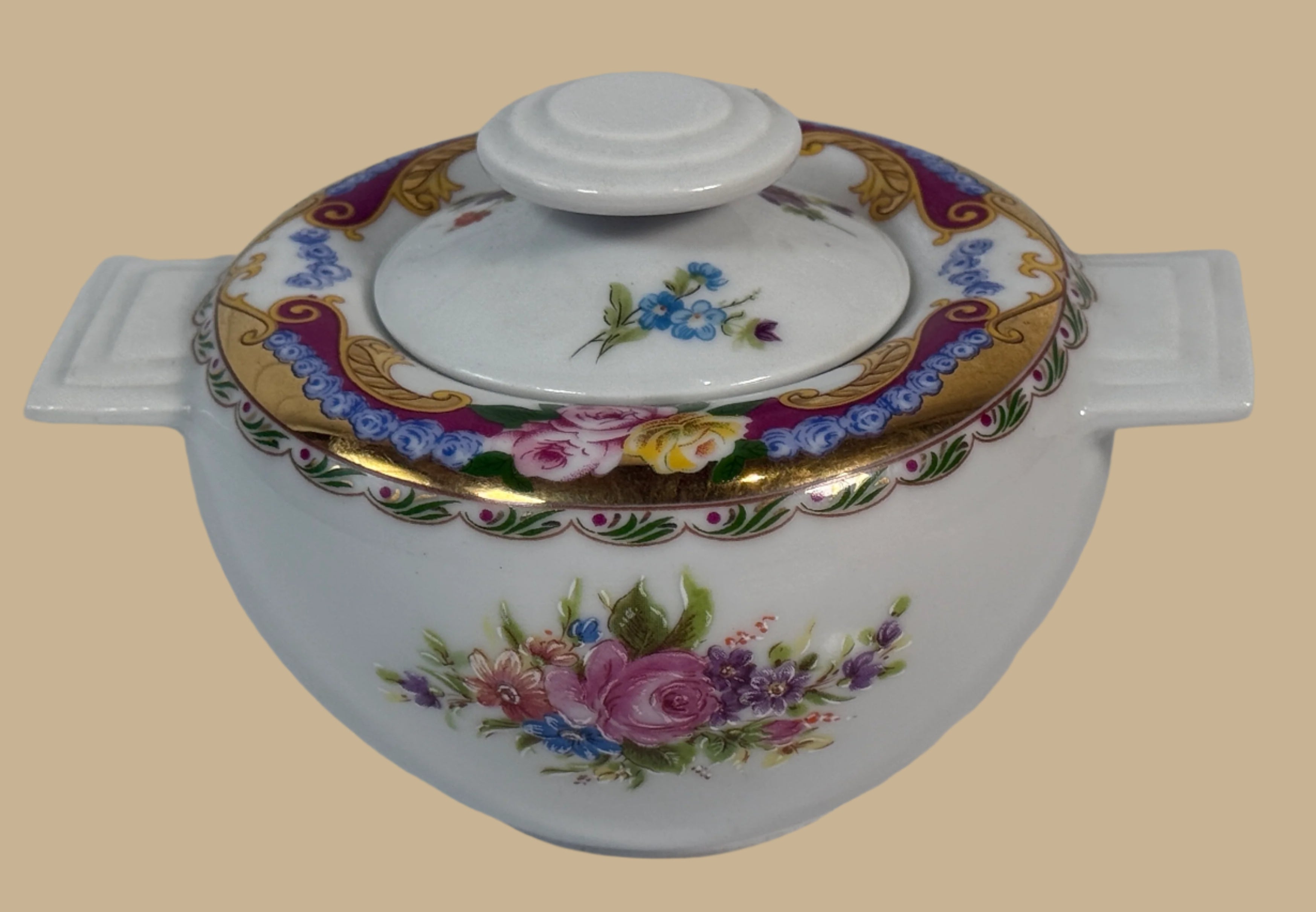 Decorative ceramic pot with floral patterns on a white background