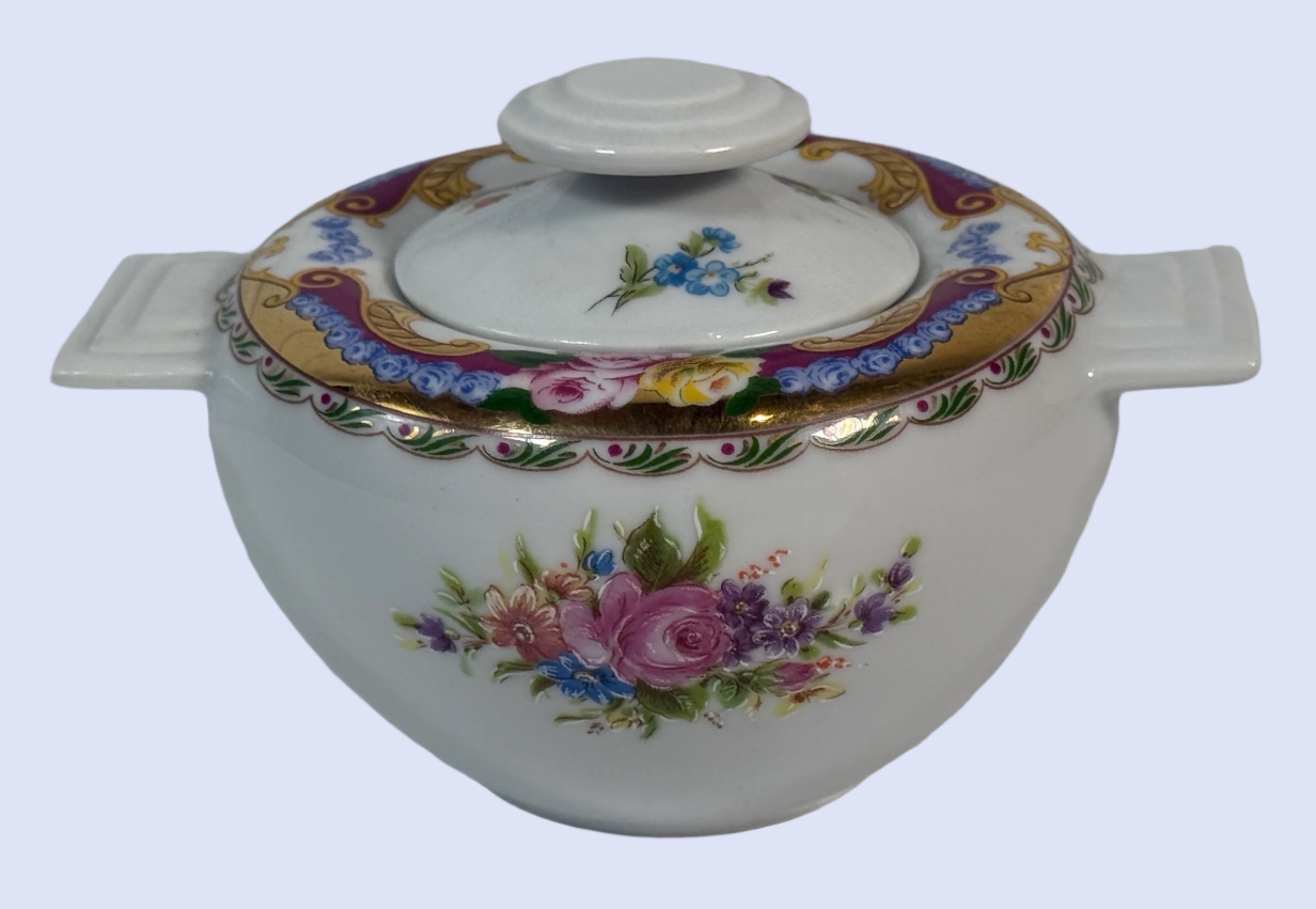Decorative ceramic pot with floral designs on a white background
