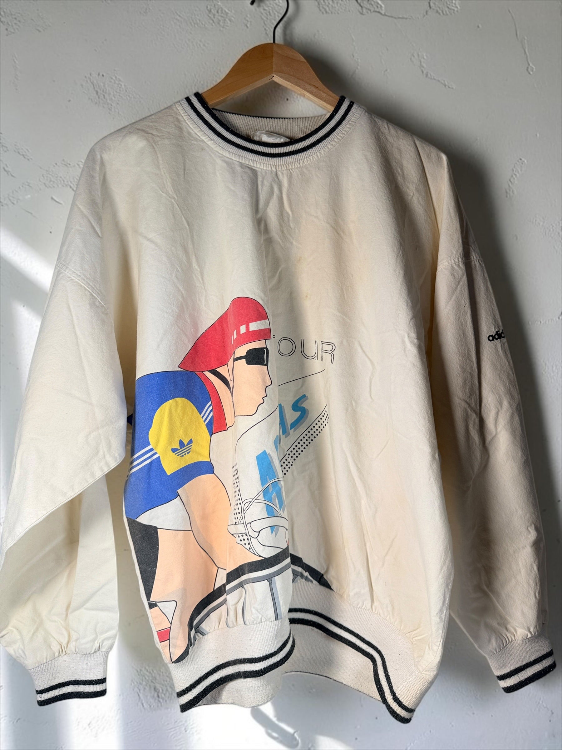 Vintage 80s Adidas cycling pullover in L/XL with bold cyclist graphics and CYCLING back print. 100% cotton. Vintage condition with visible stains.