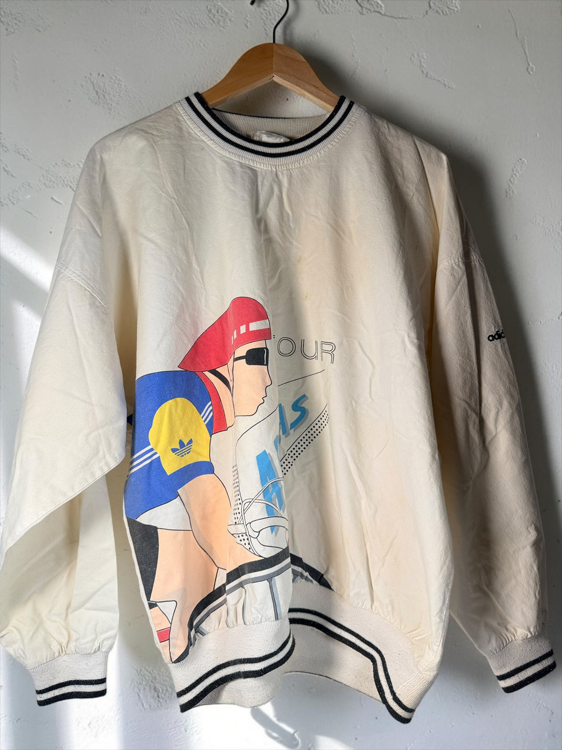 Vintage 80s Adidas cycling pullover in L/XL with bold cyclist graphics and CYCLING back print. 100% cotton. Vintage condition with visible stains.