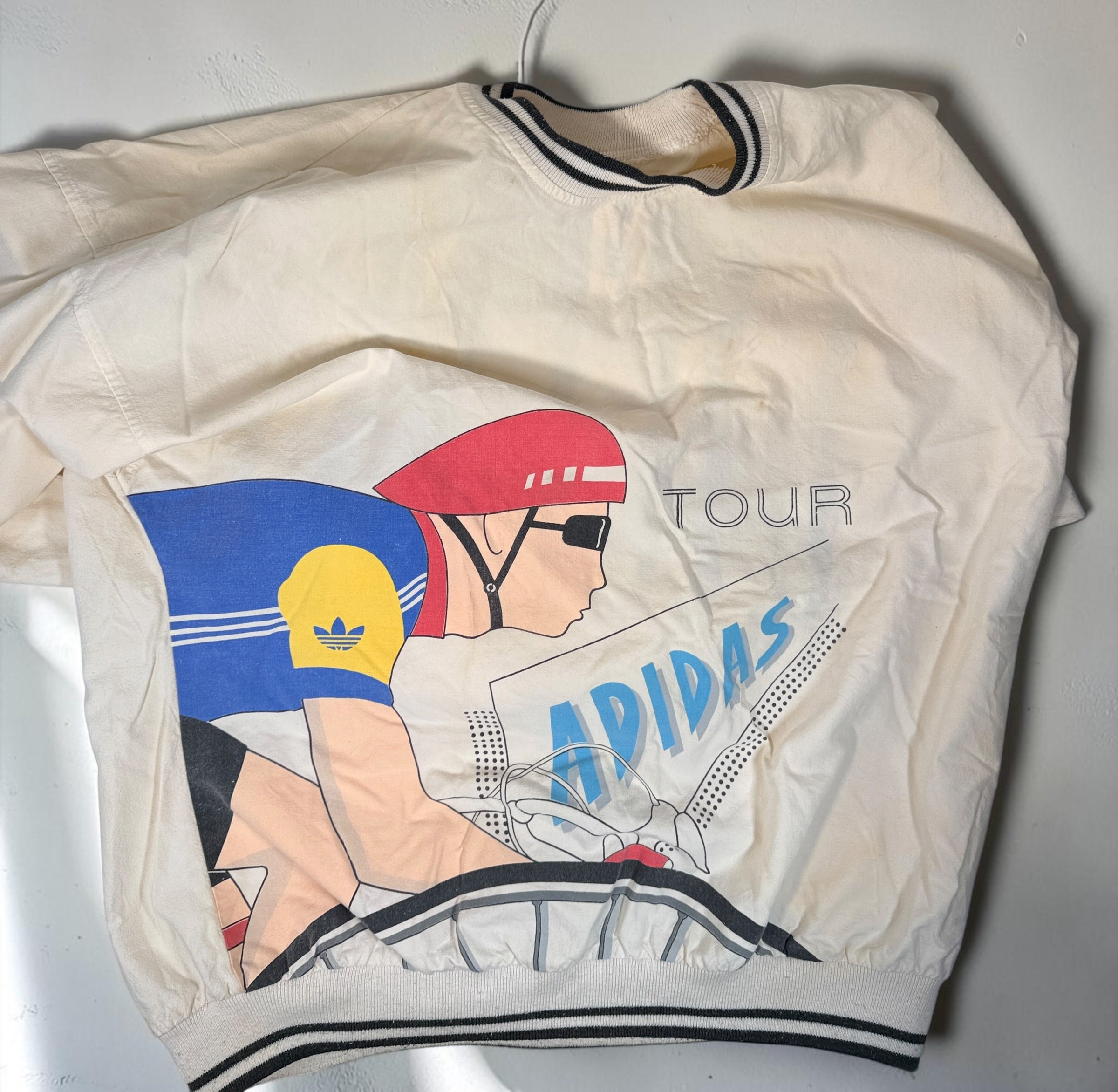 Vintage 80s Adidas cycling pullover in L/XL with bold cyclist graphics and CYCLING back print. 100% cotton. Vintage condition with visible stains.