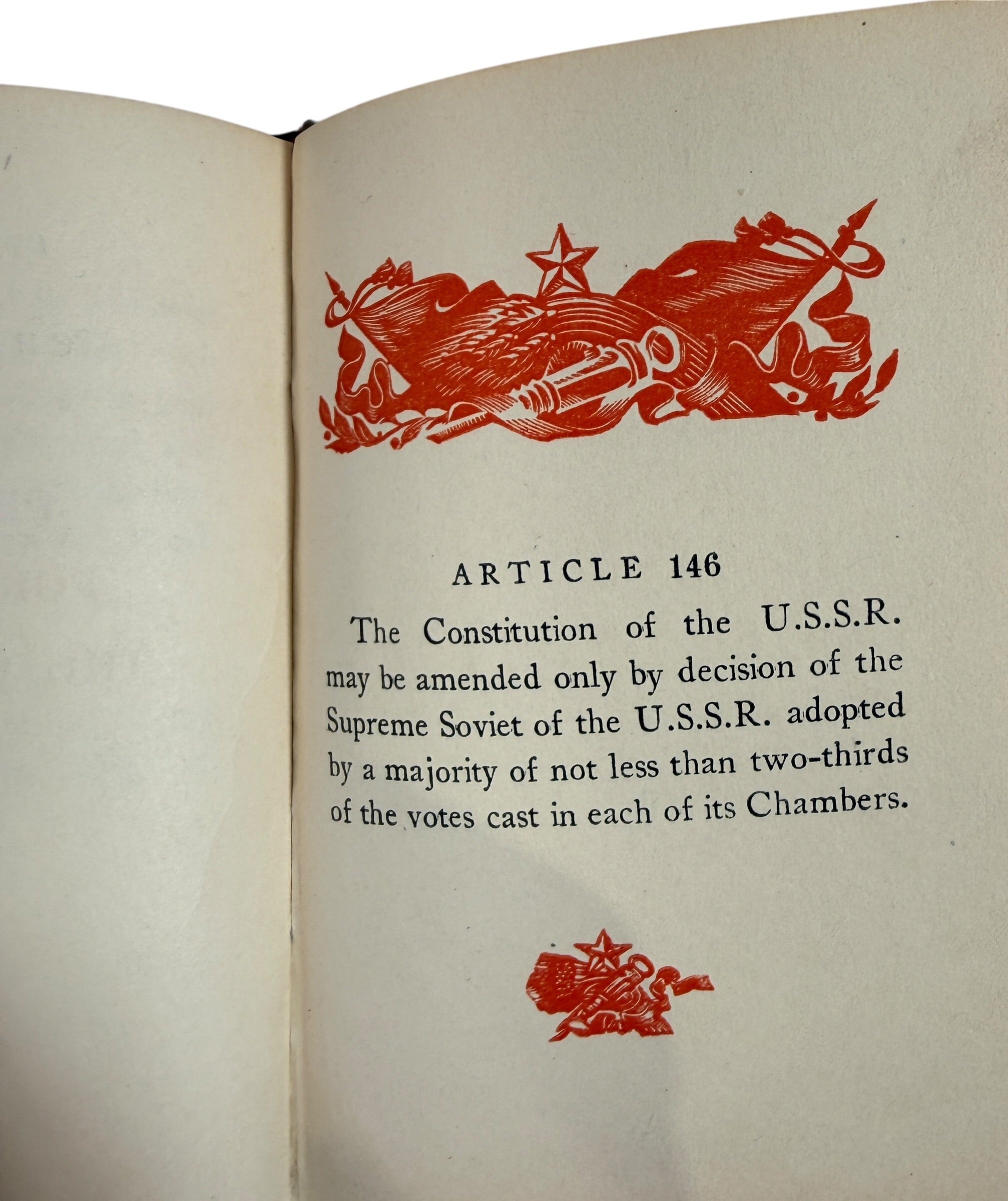 Open book with red decorative elements and text about the Constitution of the U.S.S.R.