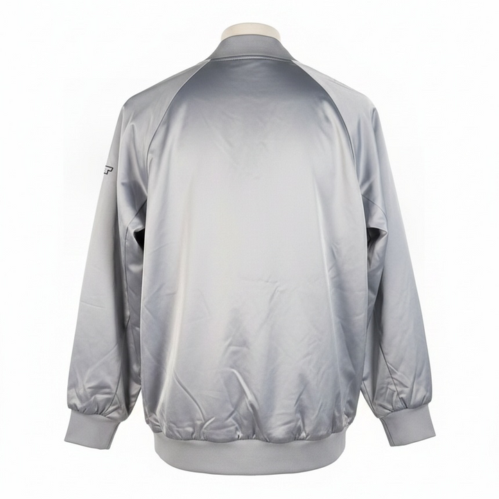 Shop the Marciano Limitless bomber jacket in silver-grey satin, size M. Original tags attached, zip pockets and ribbed trim. Minor marks disclosed.