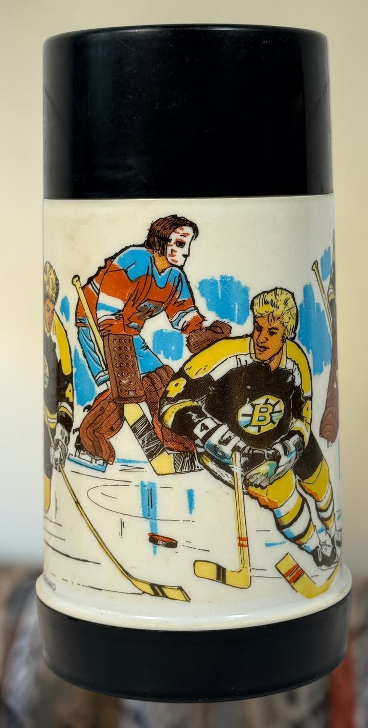 Vintage 1974 Bobby Orr Boston Bruins Aladdin thermos made in Canada with colourful hockey graphics, glass liner, stopper and original cup/lid.