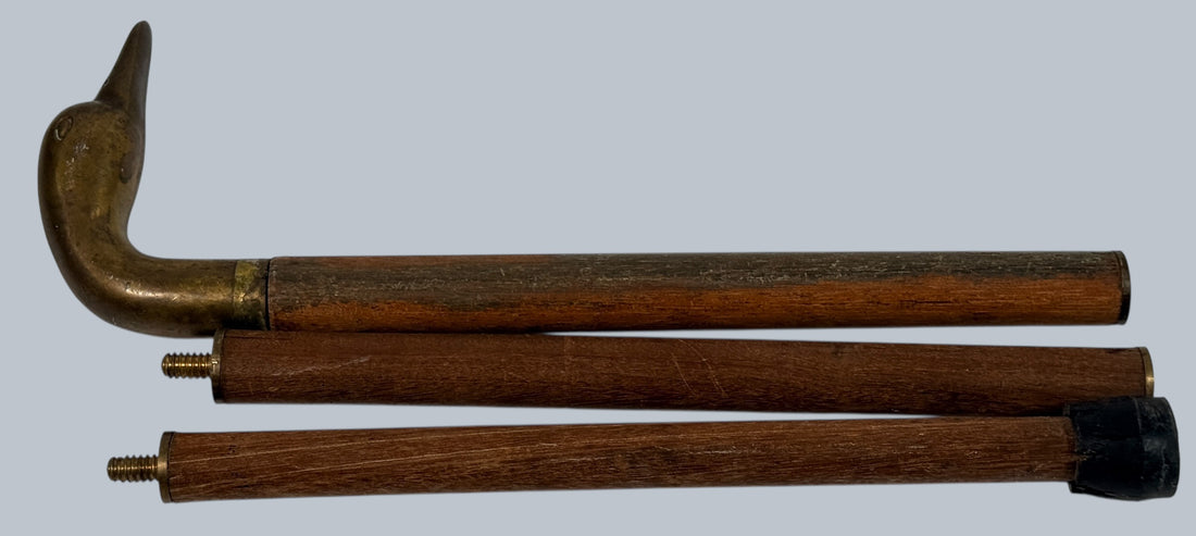 Vintage brass duck head walking cane with 3-piece wooden shaft. Collapsible travel design, aged patina, and classic gentleman’s style.
