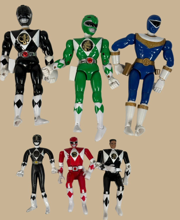 Set of six Power Ranger action figures in black, green, blue, red, and black with red and white figure on a white background