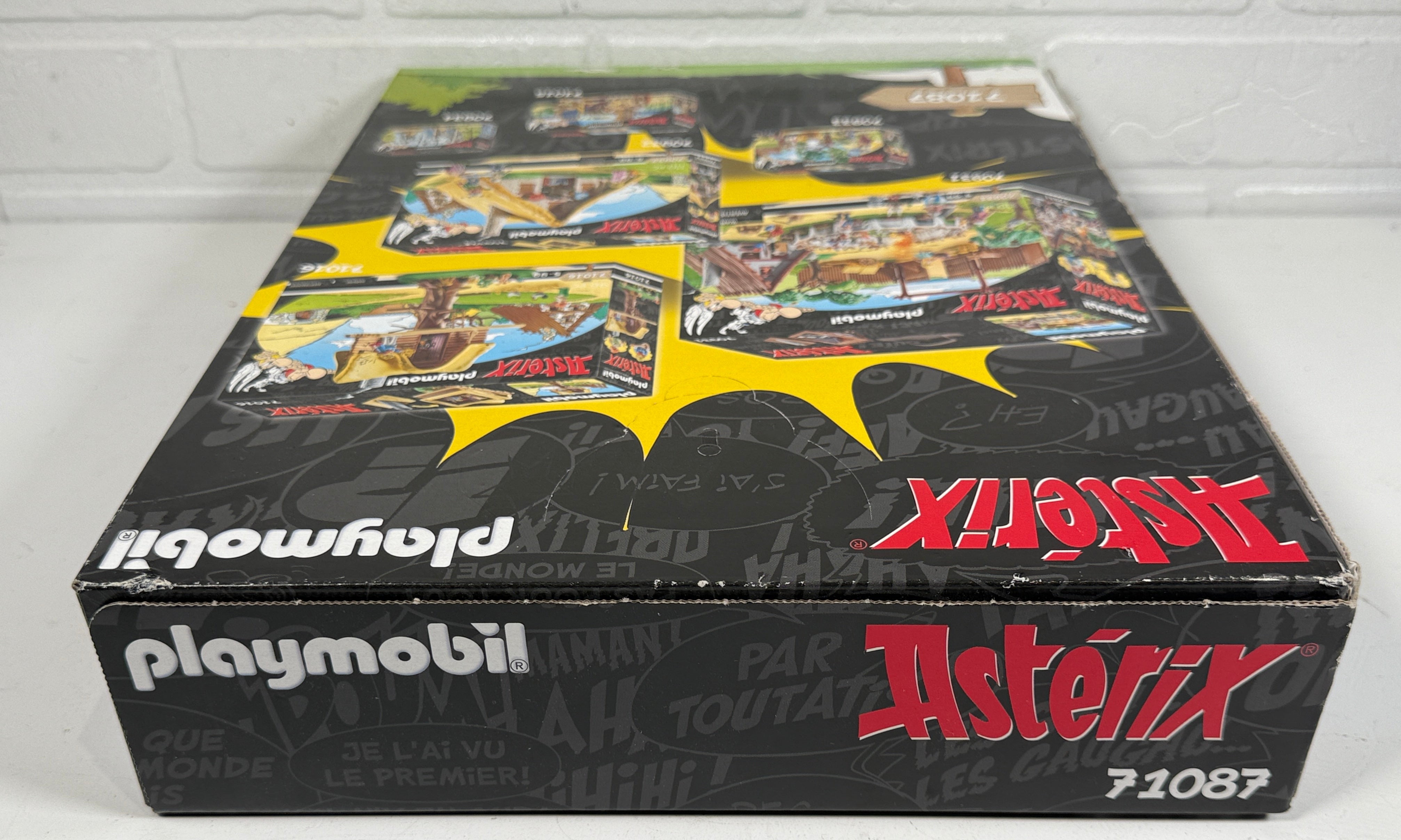 Playmobil Asterix toy set packaging against a white brick wall.