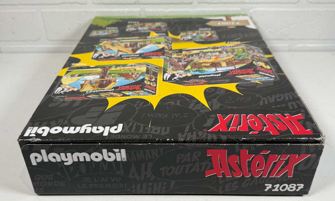 Playmobil Asterix toy set packaging against a white brick wall.