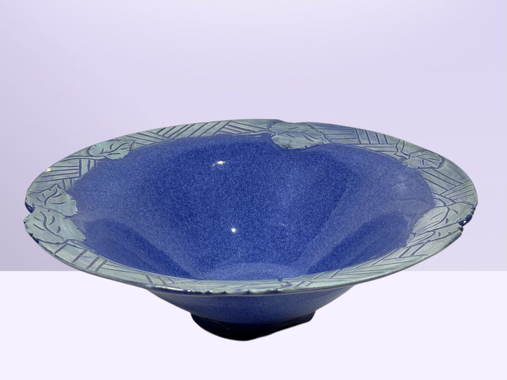 Signed studio pottery bowl with cobalt blue glaze and leaf rim detail. Handmade decorative ceramic centerpiece bowl ideal for modern rustic home decor.