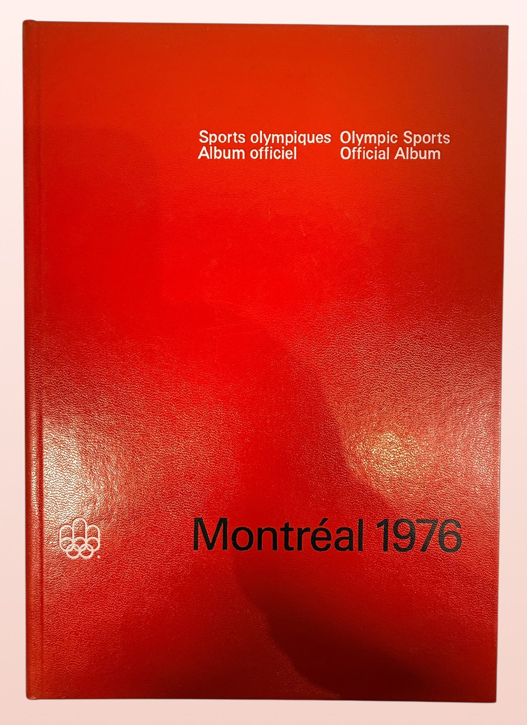 Official 1976 Montreal Olympics hardcover album bilingual Olympic sports reference book vintage Olympic memorabilia collectible Canada Games souvenir.