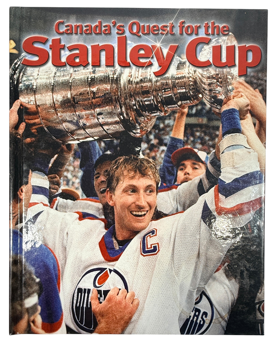 Vintage Stanley Cup hockey history book featuring iconic Canadian teams, archival photos and championship moments. Great sports collectible or gift.