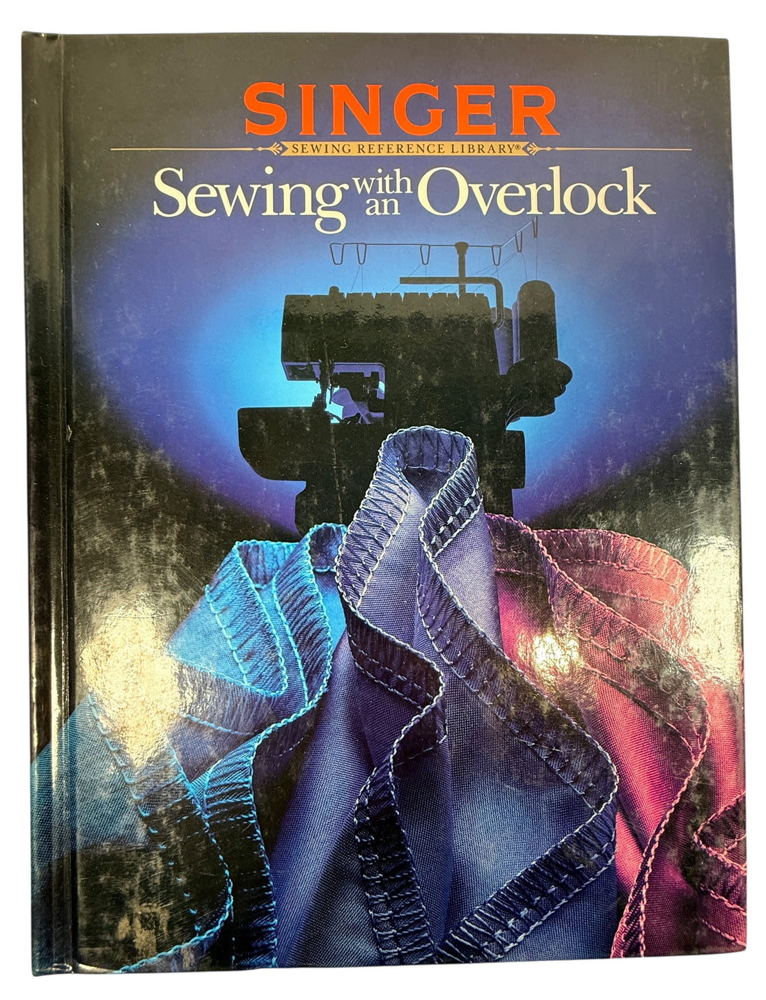 Vintage Singer sewing guide covering overlock and serger techniques. Practical hardcover reference book for garment construction, stitching and sewing projects.