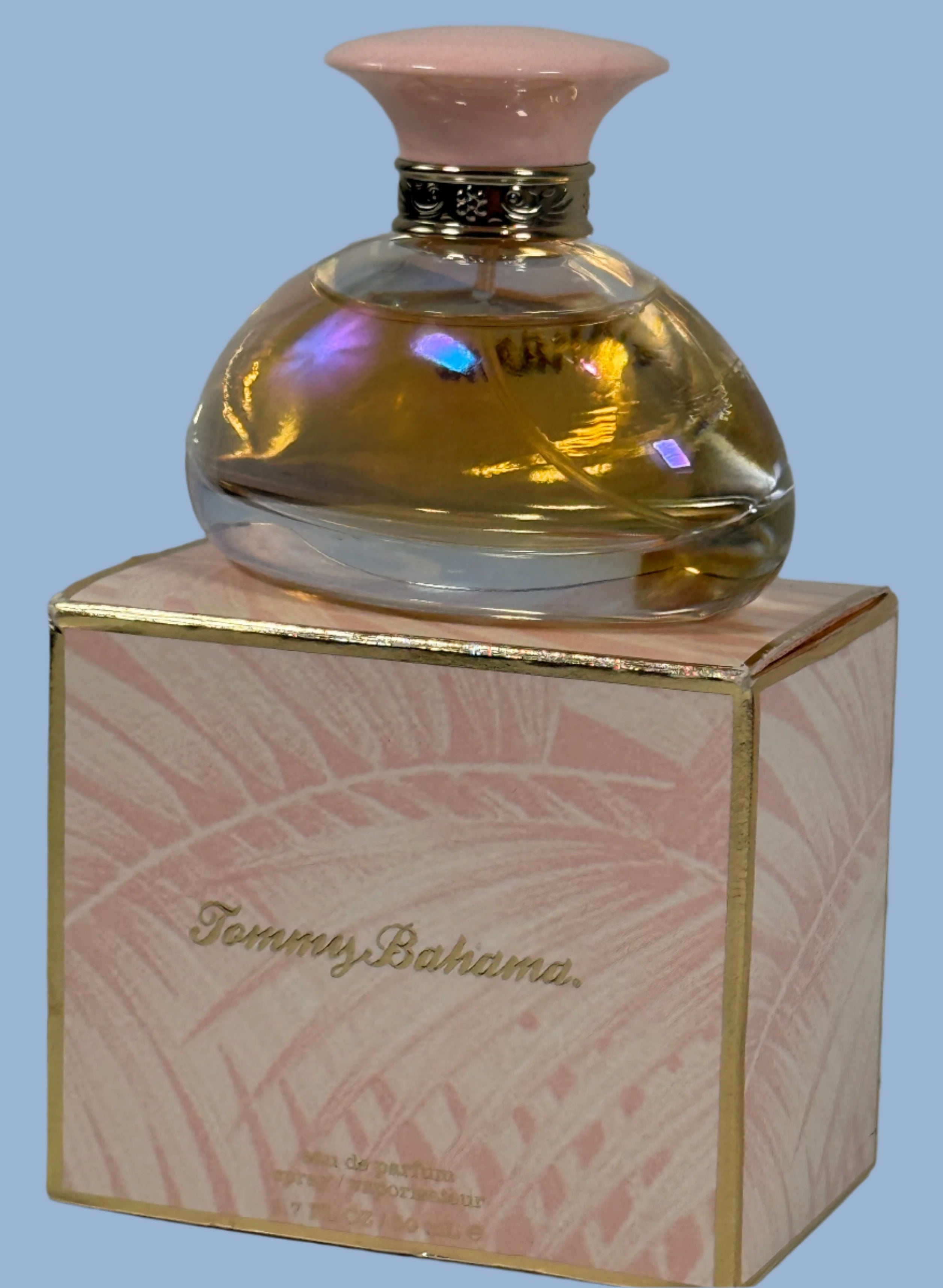 Tommy Bahama perfume bottle on its packaging with a light pink cap.