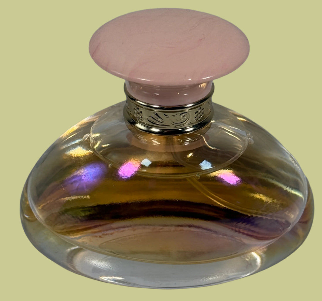 Perfume bottle with a pink cap on a white background