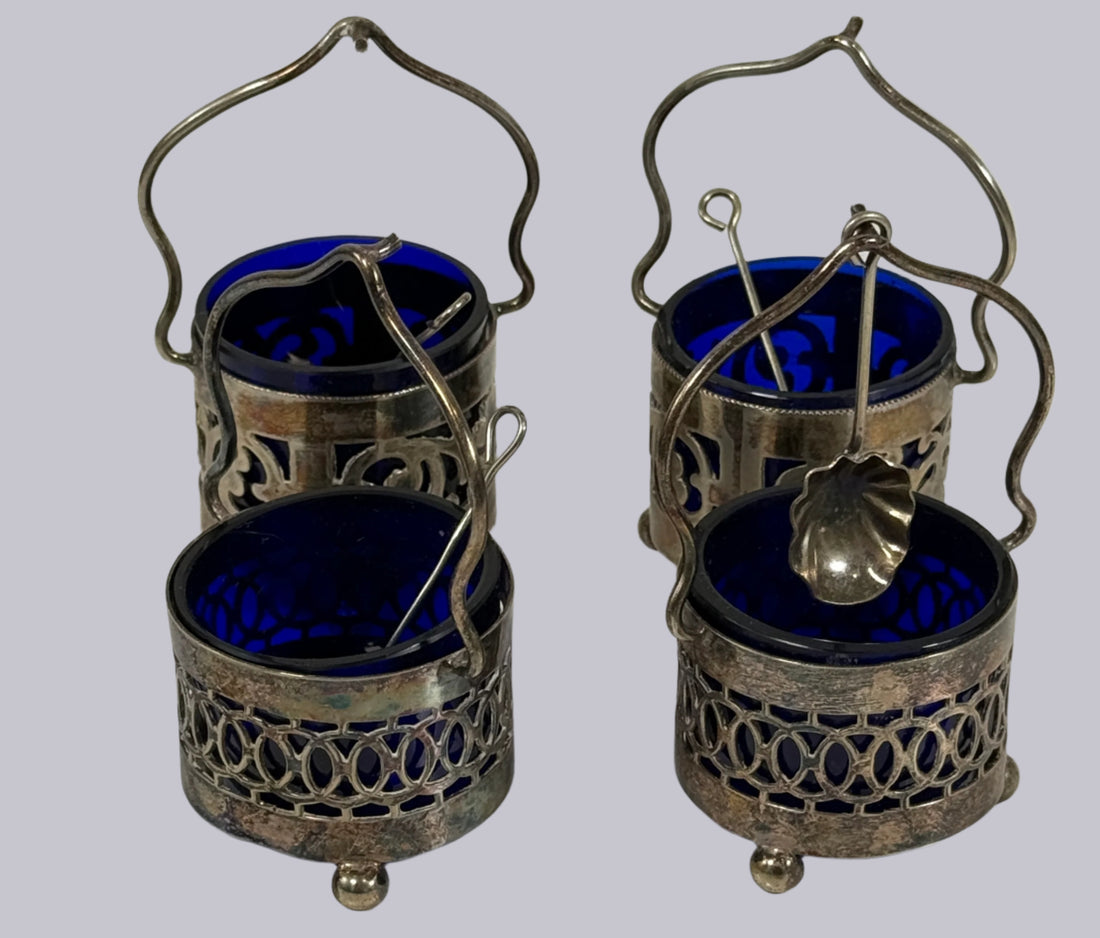 Set of four silver and blue containers with spoons on a white background