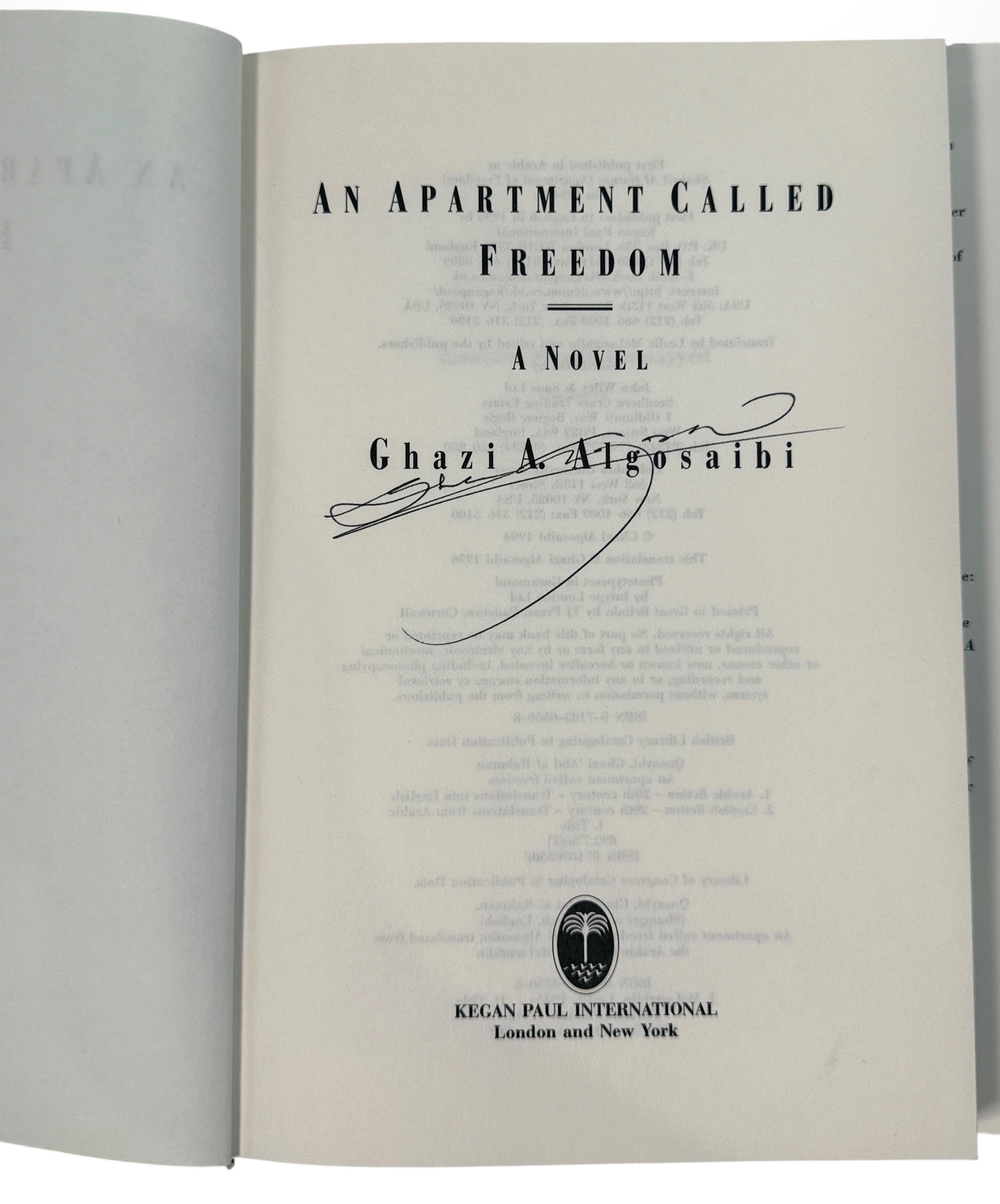 Signed 1996 first English edition of An Apartment Called Freedom by Ghazi Algosaibi. Hardcover with dust jacket, inscription and dated signature