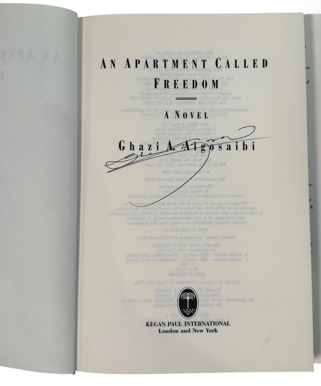 Signed 1996 first English edition of An Apartment Called Freedom by Ghazi Algosaibi. Hardcover with dust jacket, inscription and dated signature