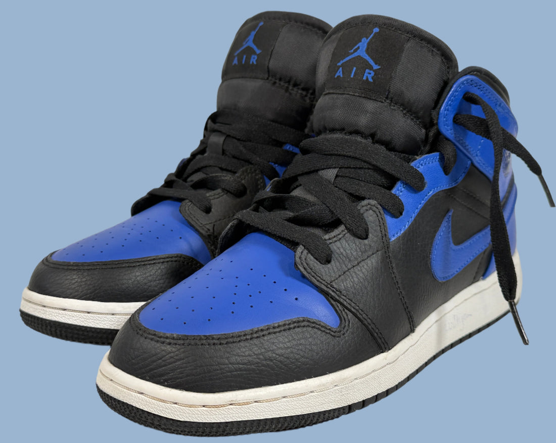 Black and blue high-top sneakers with 'Air' logo on a light gray background
