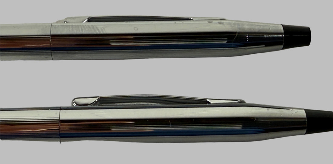 Two pens with metallic and black accents on a textured surface