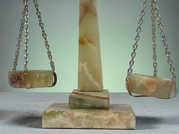 Vintage onyx marble justice scale with brass balance arms. Elegant legal office desk décor featuring natural stone veining. Decorative collectible display piece.