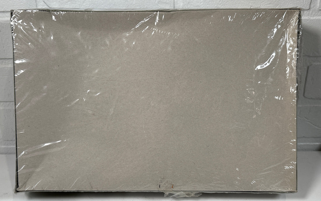 Box wrapped in clear plastic on a gray surface