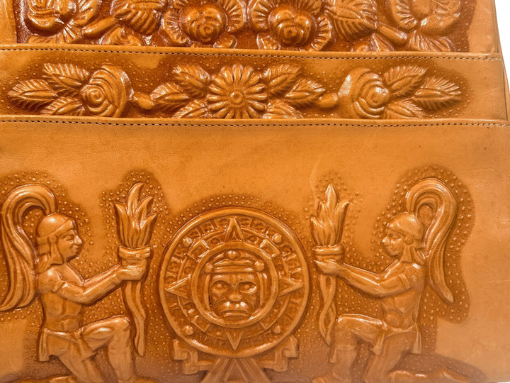 Vintage tooled leather handbag with Aztec motif. Mexican artisan carved shoulder purse, structured boho accessory with strong vintage character and collector appeal.