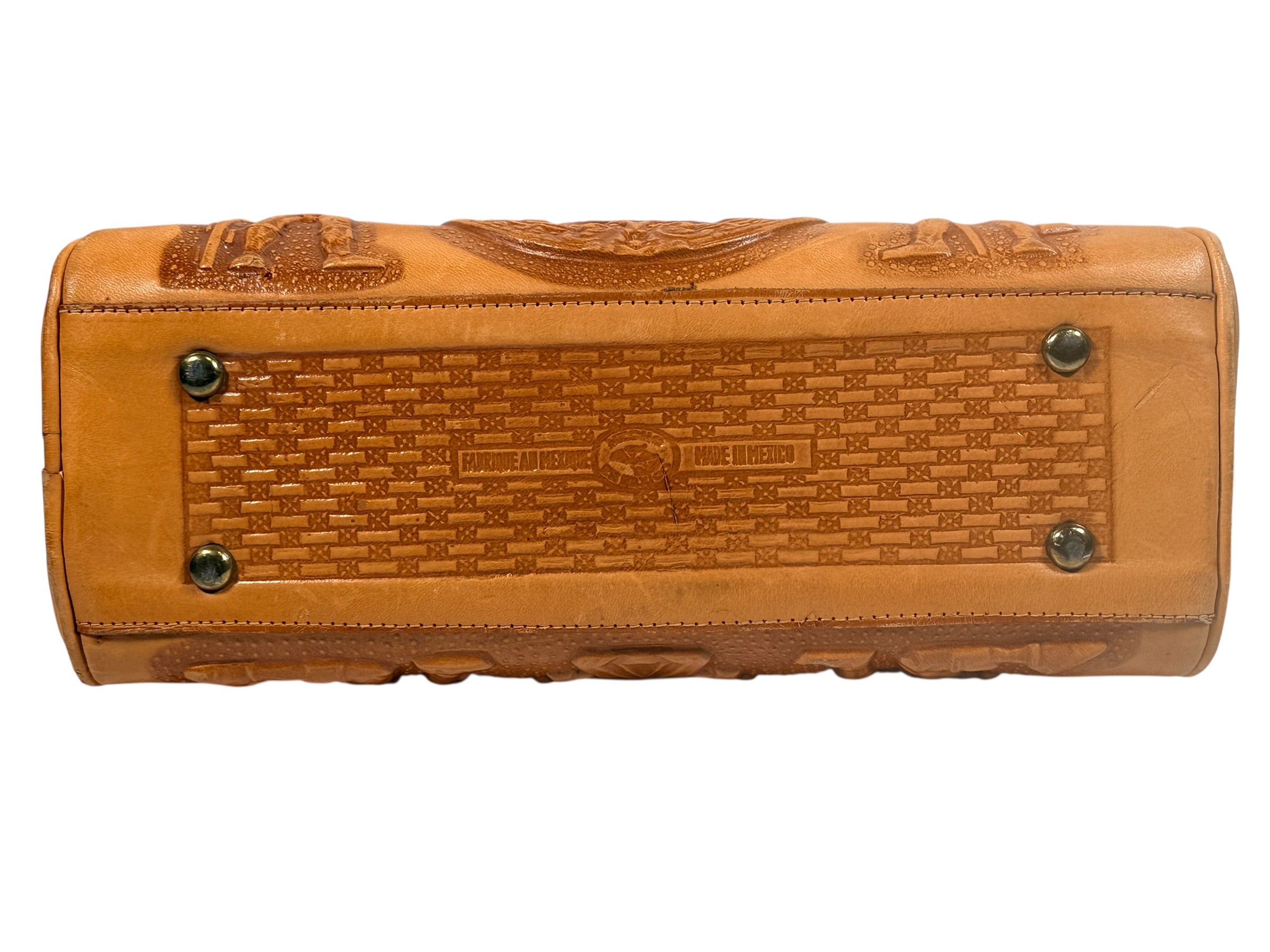 Vintage tooled leather handbag with Aztec motif. Mexican artisan carved shoulder purse, structured boho accessory with strong vintage character and collector appeal.