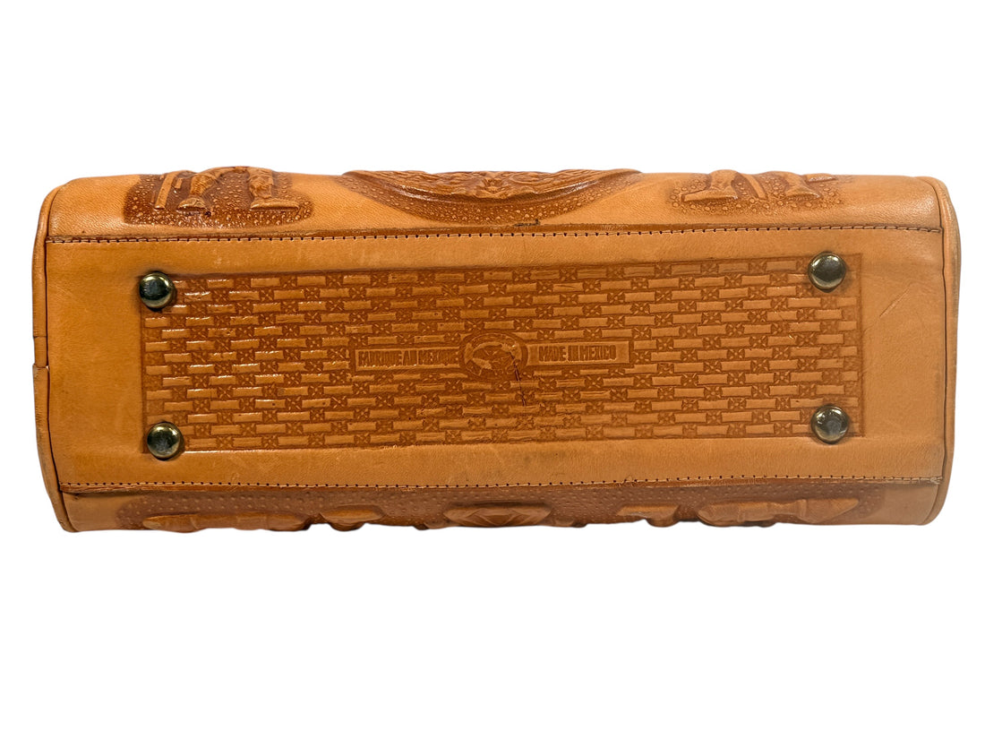 Vintage tooled leather handbag with Aztec motif. Mexican artisan carved shoulder purse, structured boho accessory with strong vintage character and collector appeal.